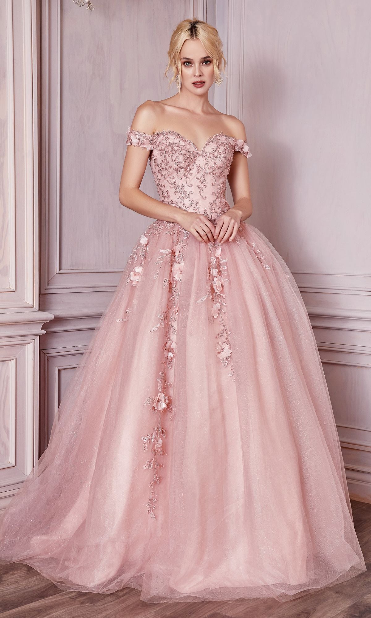 A woman in the Off-Shoulder Long Sweetheart Prom Ball Gown CD0185, featuring delicate floral-lace appliques, stands indoors against a pale paneled wall.